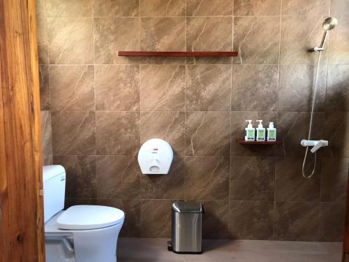 a bathroom with a toilet and a shower at Daraga ดารกะ in Chiang Dao