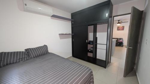 a bedroom with a bed and a black cabinet at Everest 663 in Monterrey