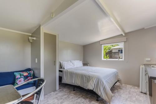 a bedroom with a bed and a window at Linkwater Wonder - Marlborough Holiday Home in Picton