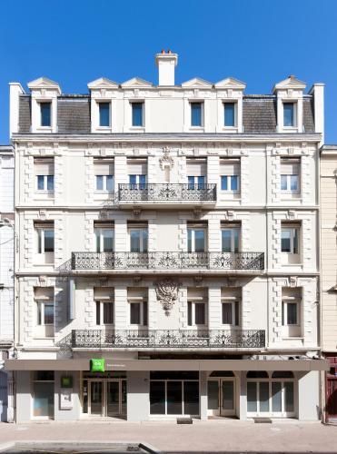 a large white building with balconies on it at ibis Styles Roanne Centre Gare in Roanne