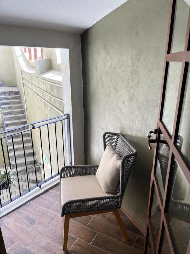 a chair with a pillow sitting on a balcony at Eonia in Atlixco