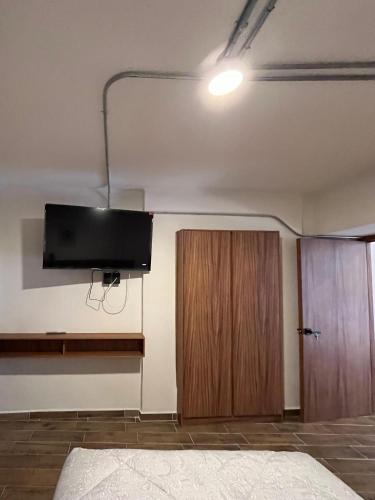 a room with a flat screen tv on the wall at Eonia in Atlixco