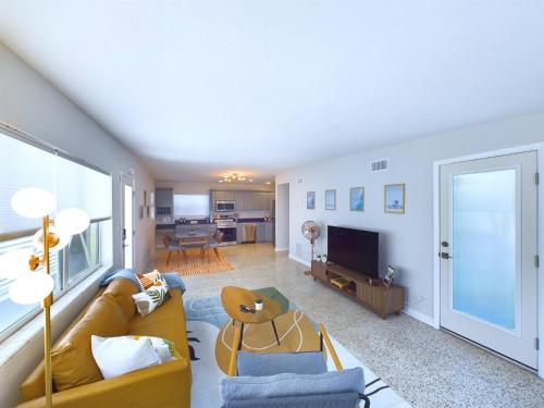 a living room with a couch and a television at The Seaside Launch Pad in Cape Canaveral - NEW! in Cape Canaveral