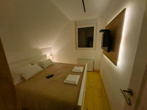 a bedroom with a bed with two towels on it at Moje srećno mesto in Arandjelovac