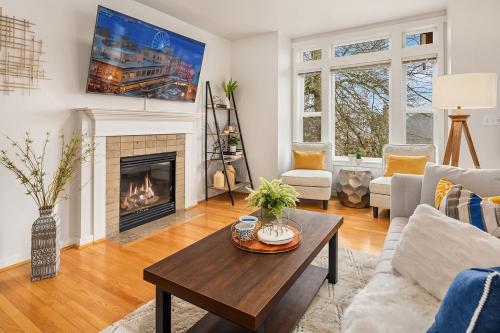 a living room with a fireplace and a table at Cheerful Capitol Hill Home AC and 98 Walk Score in Seattle