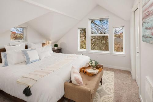 a white bedroom with a large bed and windows at Cheerful Capitol Hill Home AC and 98 Walk Score in Seattle