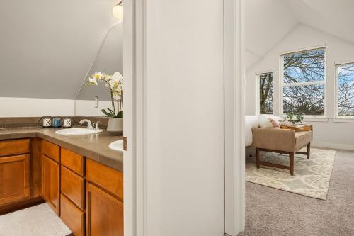 a bathroom with a sink and a chair in a room at Cheerful Capitol Hill Home AC and 98 Walk Score in Seattle