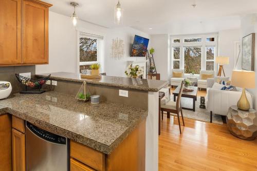 a kitchen and living room with a kitchen counter and a living room at Cheerful Capitol Hill Home AC and 98 Walk Score in Seattle