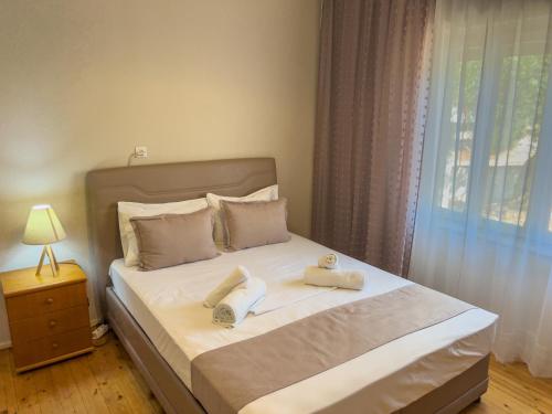 a bedroom with a bed with two towels on it at Sivi's Vacation Homes in Skala Kallirachis