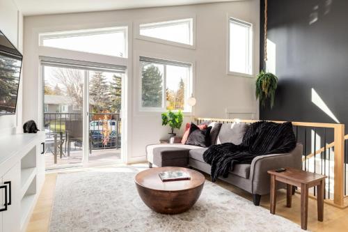 a living room with a couch and a coffee table at Free Parking, Perfect Family Home with King Bed in Calgary