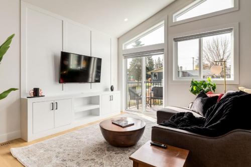 a living room with a couch and a tv at Free Parking, Perfect Family Home with King Bed in Calgary