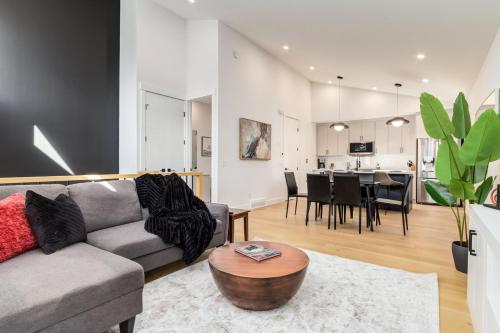 a living room with a couch and a table at Free Parking, Perfect Family Home with King Bed in Calgary