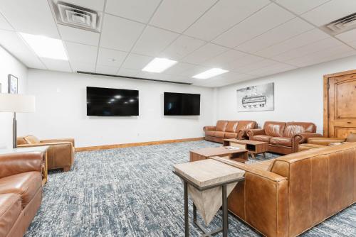 a waiting room with leather furniture and a flat screen tv at Newly Renovated Studio at Silverado, Ski, Relax, Enjoy World Class Amenities! in Park City