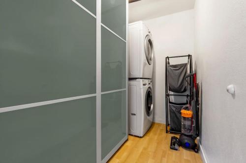 a small laundry room with a washer and dryer at Modern and Relaxing Lake Sammamish View House in Issaquah