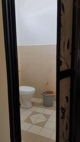 a bathroom with a toilet and a bucket at AMAN Homestay Senawang musliim only in Senawang