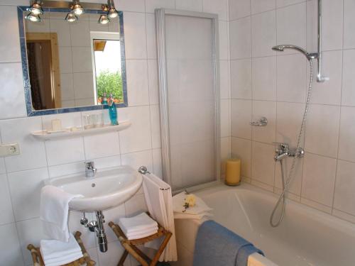 a bathroom with a sink and a bath tub at Pension Jageredt in Nussbach