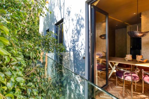 a room with a glass wall with a table and some plants at El Alfonsa in Mexico City