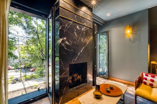 a living room with a fireplace in front of a window at El Alfonsa in Mexico City