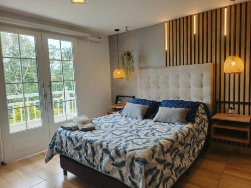 a bedroom with a large bed with a blue comforter at Hope Aparta Lofts in Salento