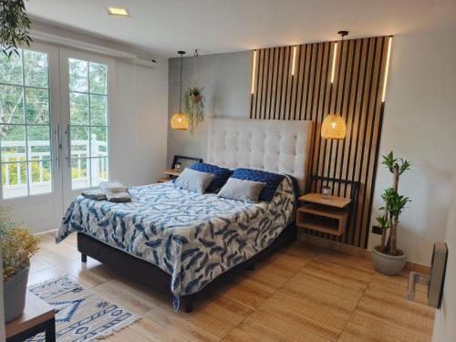 a bedroom with a bed with a blue comforter at Hope Aparta Lofts in Salento