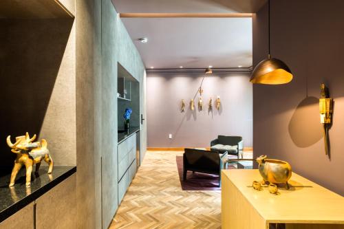a living room with a table and a chair at El Alfonsa in Mexico City