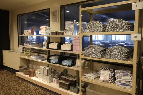 a store shelf filled with lots of products at Hotel Japan Shiga in Yamanouchi