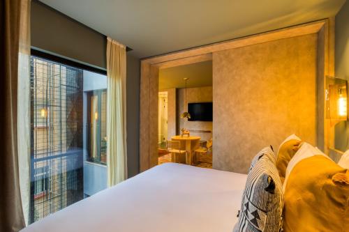a bedroom with a bed and a large window at El Alfonsa in Mexico City