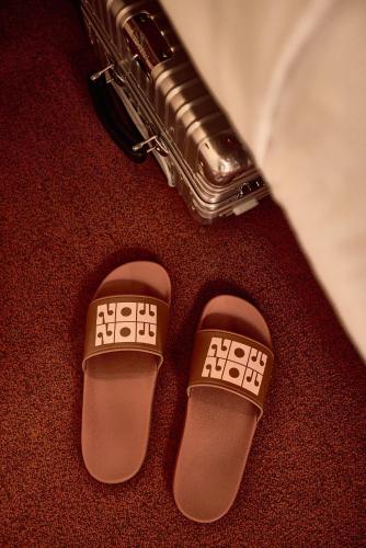 a pair of shoes and a saxophone on a floor at Now Now NoHo in New York