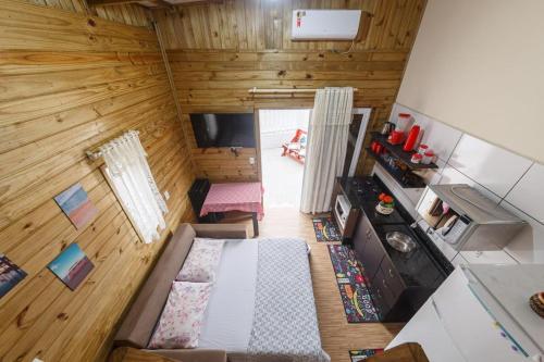 an overhead view of a living room and kitchen in a tiny house at Casa Perto das melhores praias Florianópolis, 8 pessoas, ar condicionado, tv, wifi, cozinha completa, lavanderia, in Florianópolis