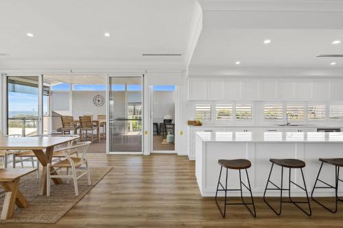 a kitchen and dining room with a table and chairs at Norman Views - 20 Panorama Crescent in Normanville