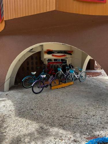two bikes parked in a garage under a building at Beach View Room at Barnacle Resort in Big Pine Key