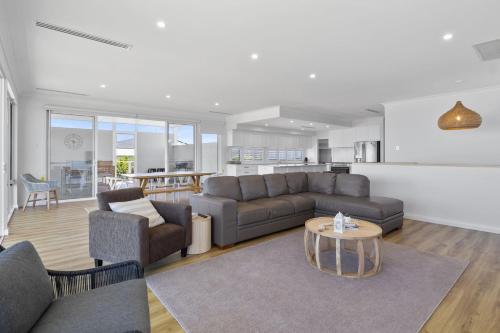 a living room with a couch and a table at Norman Views - 20 Panorama Crescent in Normanville