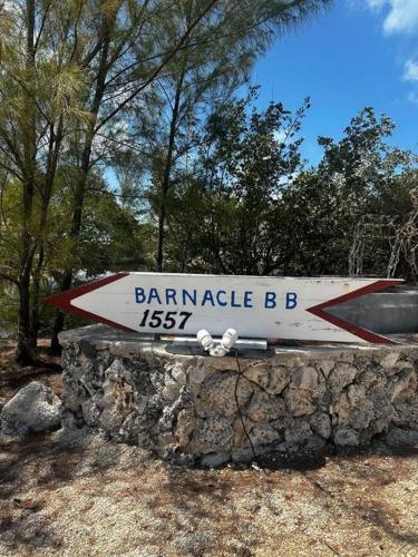 a street sign on top of a stone wall at Beach View Room at Barnacle Resort in Big Pine Key