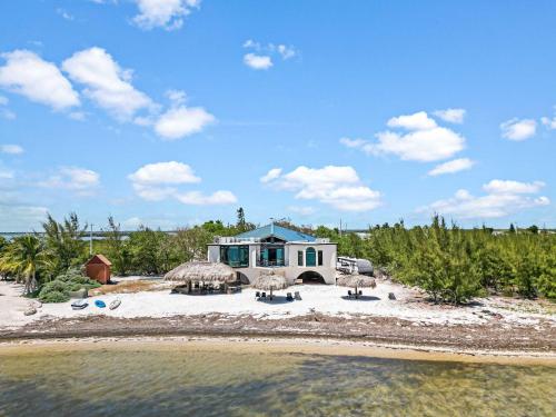 a house on the beach with a view of the water at Star Room at Barnacle Resort in Big Pine Key