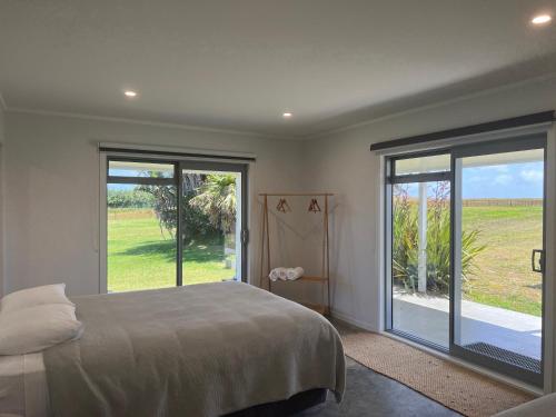 Postel nebo postele na pokoji v ubytování Wharekapua Beach House