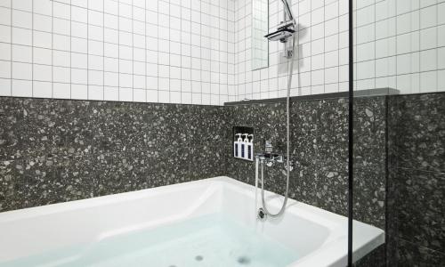 a bathroom with a bath tub and a shower at JustSleep Namyangju Dasan in Namyangju