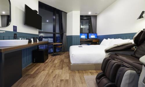 a hotel room with a bed and a sink at JustSleep Namyangju Dasan in Namyangju