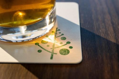 a glass of whisky sitting on a table at YUKARA LEAF LODGE in Nanae