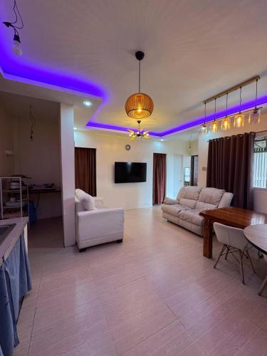 a living room with purple lights on the ceilings at Viewleaf Resort Hotel in Marikina