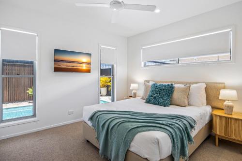 a bedroom with a bed and a window at Premium 4-Bed Coastal Escape with BBQ and Pool in Peregian Beach