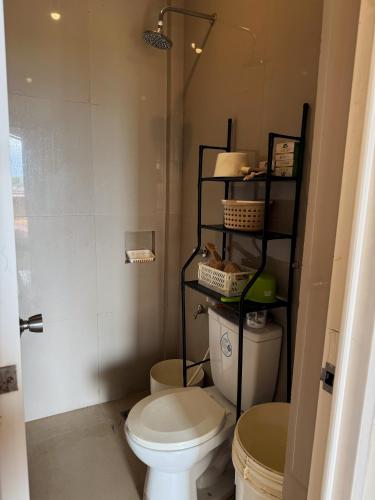 a small bathroom with a toilet and a shower at Viewleaf Resort Hotel in Marikina