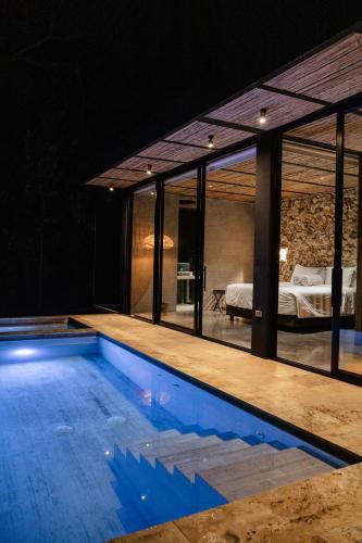 a house with a swimming pool and a bedroom at Colina Bio Hotel in Los Curos