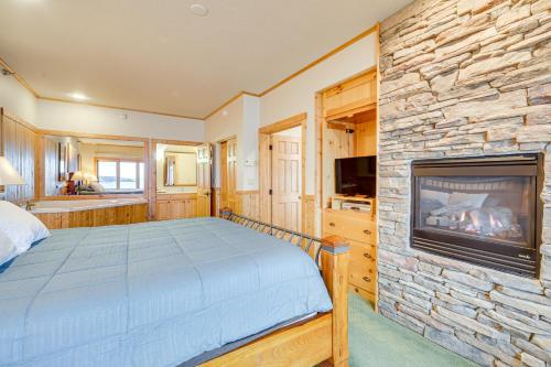 a bedroom with a bed and a fireplace at Pool and Lake Access Northern Lakes Retreat! in Two Harbors