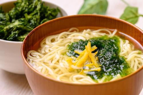 a bowl of noodles and broccoli on a table at Hotel Green Park Tsu in Tsu