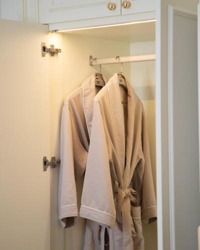 a robe hanging on a rack in a bathroom at THE PREMIER PALACE HOTEL AND SPA in Phnom Penh