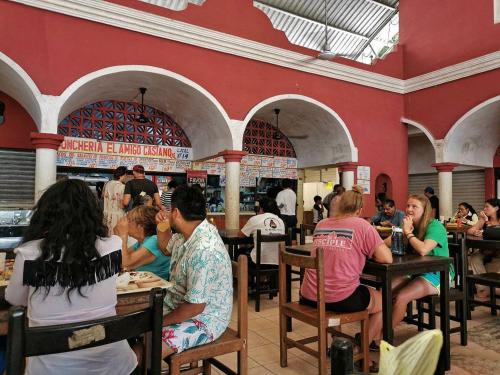 a group of people sitting at tables in a restaurant at Casa Vidal Hotel in Valladolid