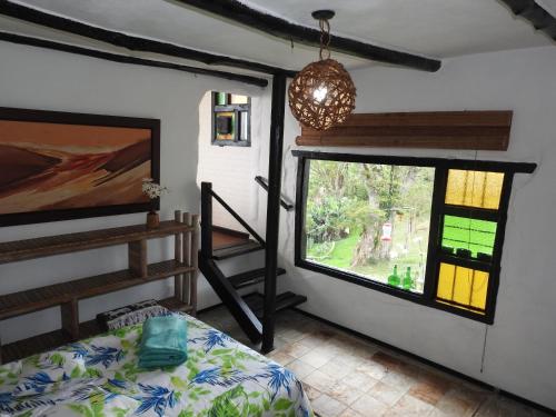 Una cama o camas en una habitación de Finca Bello Horizonte Cali
