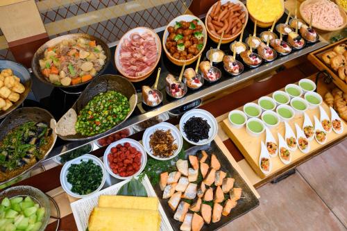 a buffet filled with lots of different types of food at Hotel Green Park Tsu in Tsu