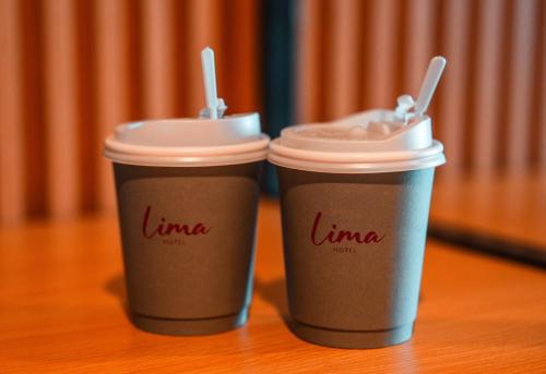 two cups of coffee sitting on a table at Lima Hotel in Phra Nakhon Si Ayutthaya