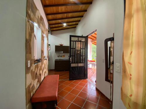 a hallway with a door leading to a room with a table at Cabaña Campestre - Puente Nacional in Puente Nacional